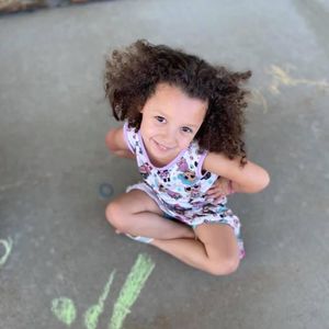 girl doing sidewalk chalk